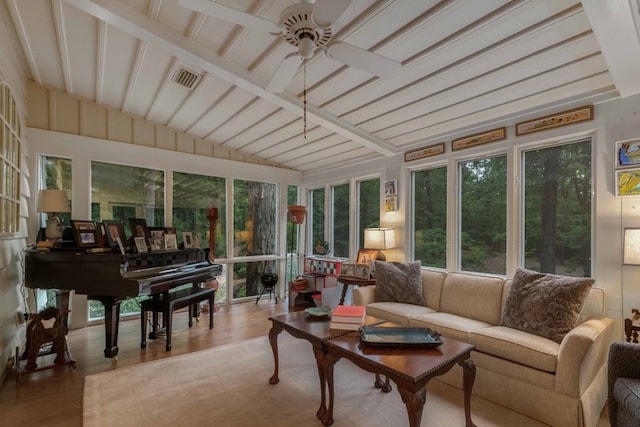 sunroom featuring vaulted ceiling with beams, visible vents, and a ceiling fan