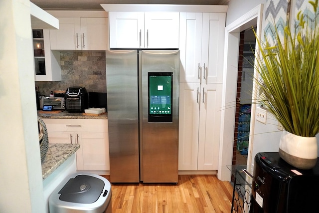 404 19th Ave, Phenix City, AL 36869 - kitchen featuring smart refrigerator, light wood finished floors, white cabinets, and decorative backsplash