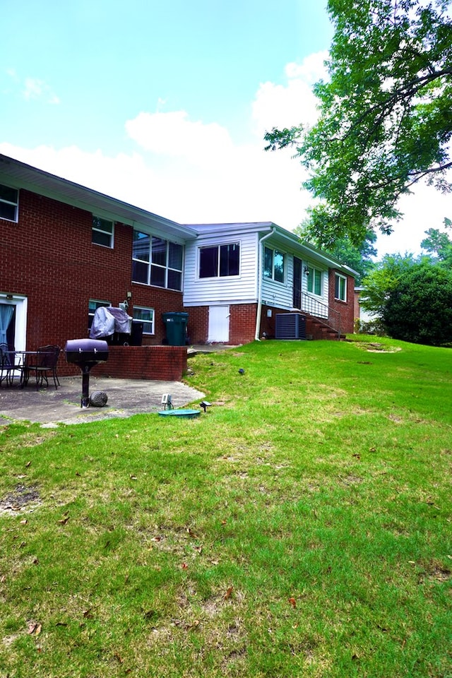 404 19th Ave, Phenix City, AL 36869 - rear view of house with brick siding, a yard, and a patio