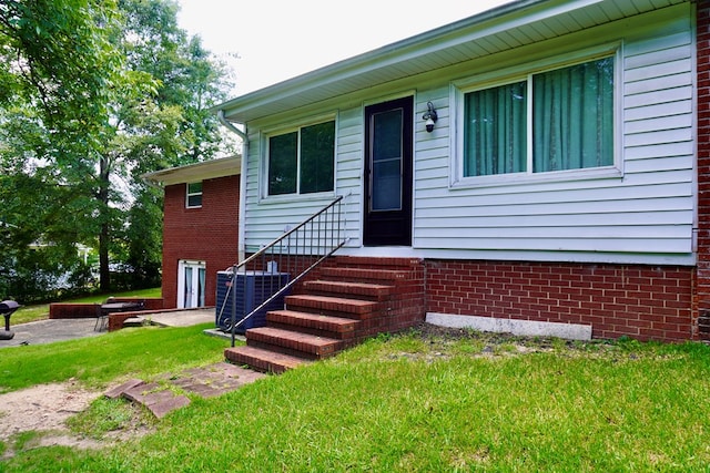 404 19th Ave, Phenix City, AL 36869 - view of front of home featuring a front lawn, entry steps, and brick siding