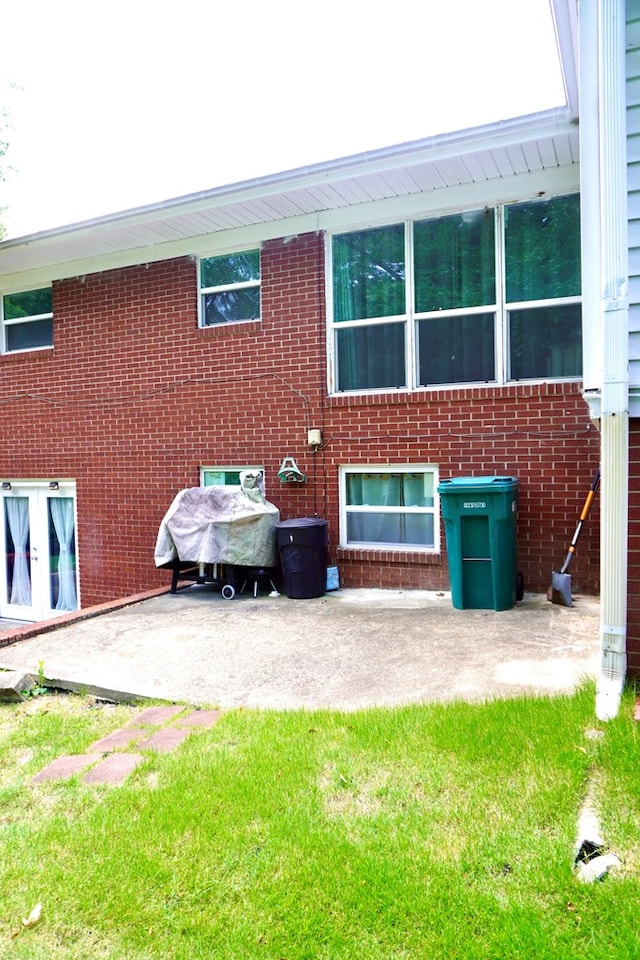 404 19th Ave, Phenix City, AL 36869 - back of house featuring a patio area, brick siding, and a lawn