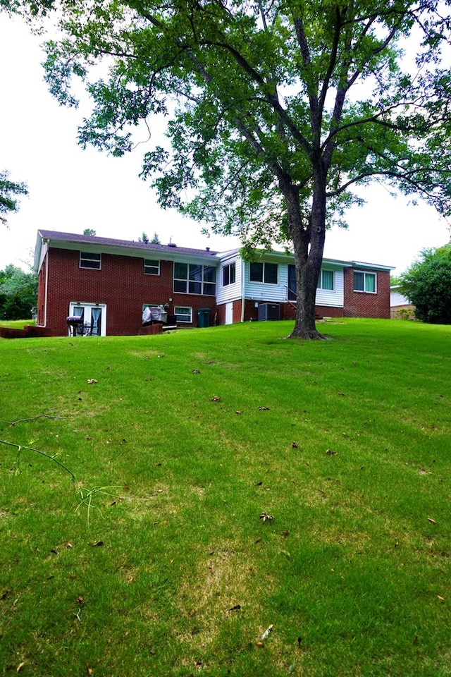 404 19th Ave, Phenix City, AL 36869 - rear view of house featuring brick siding and a yard