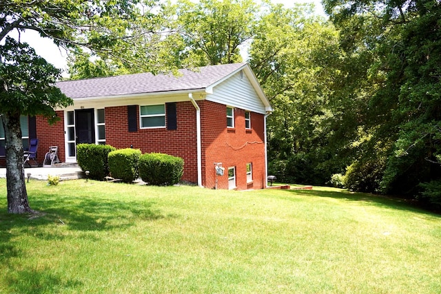 404 19th Ave, Phenix City, AL 36869 - view of front facade with brick siding, a front yard, and roof with shingles