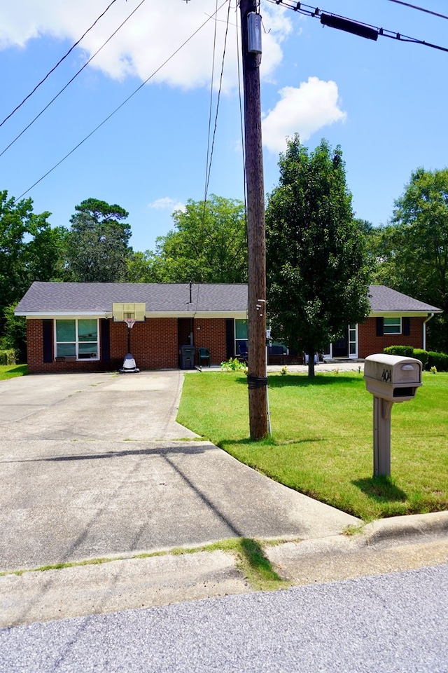 404 19th Ave, Phenix City, AL 36869 - ranch-style home with driveway, a front lawn, and brick siding