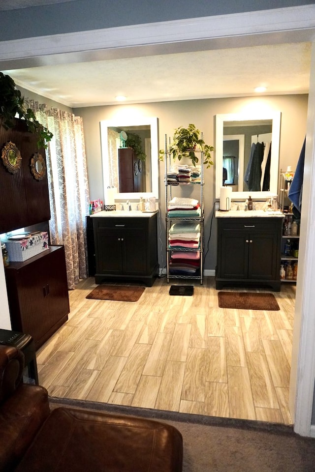 404 19th Ave, Phenix City, AL 36869 - full bath featuring wood finished floors, two vanities, and recessed lighting