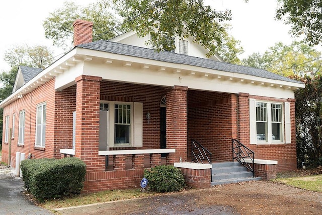 1240 Peacock Ave, Columbus, GA 31906 - view of front of property with brick siding, a chimney, and a shingled roof