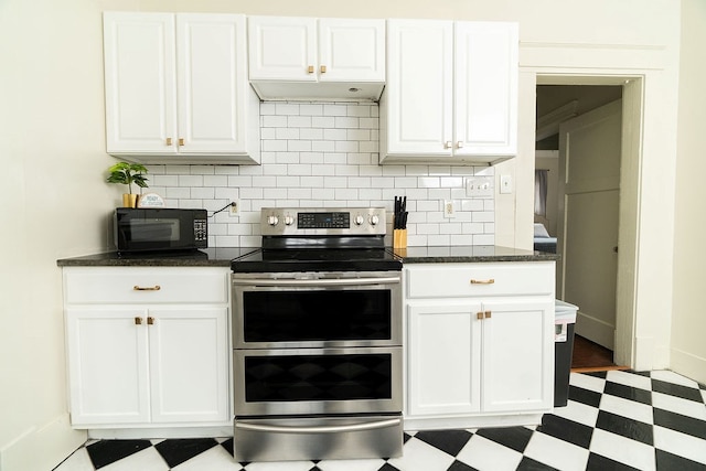 1240 Peacock Ave, Columbus, GA 31906 - kitchen with double oven range, black microwave, backsplash, and white cabinets