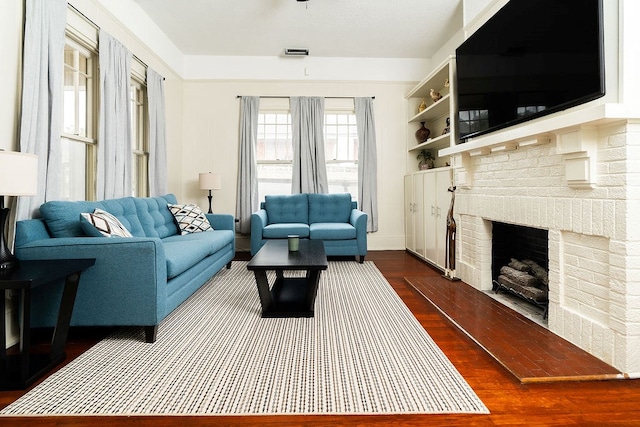 1240 Peacock Ave, Columbus, GA 31906 - living area with dark wood finished floors and a brick fireplace