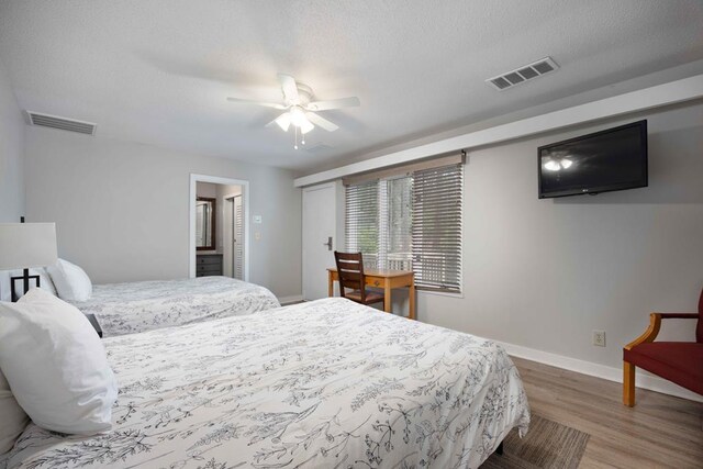 2387 Cedar Ln, Pine Mountain, GA 31822 - bedroom with wood finished floors, baseboards, ceiling fan, and a textured ceiling