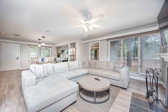 2387 Cedar Ln, Pine Mountain, GA 31822 - living area featuring wood finished floors, baseboards, ceiling fan, a textured ceiling, and a fireplace