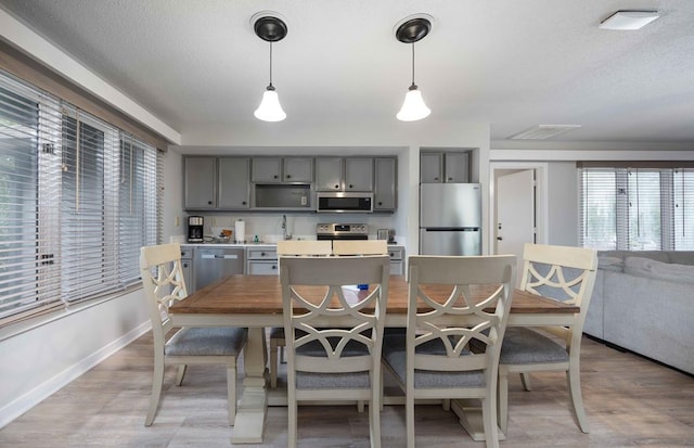 2387 Cedar Ln, Pine Mountain, GA 31822 - kitchen with appliances with stainless steel finishes, gray cabinets, a center island, decorative light fixtures, and baseboards