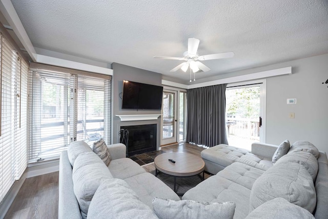2387 Cedar Ln, Pine Mountain, GA 31822 - living area with wood finished floors, ceiling fan, a textured ceiling, and a fireplace