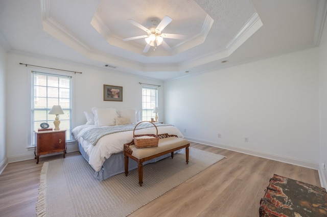 3022 Thornberry Cir, Phenix City, AL 36867 - bedroom featuring ornamental molding, a tray ceiling, light wood-type flooring, baseboards, and a ceiling fan