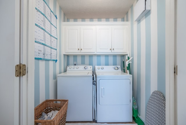 3022 Thornberry Cir, Phenix City, AL 36867 - laundry area with wallpapered walls, cabinet space, washer and clothes dryer, and a textured ceiling