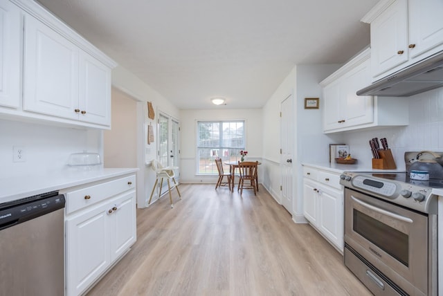 3022 Thornberry Cir, Phenix City, AL 36867 - kitchen featuring stainless steel appliances, light wood-style floors, light countertops, white cabinetry, and under cabinet range hood
