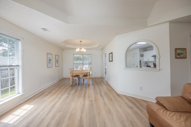 3022 Thornberry Cir, Phenix City, AL 36867 - dining space with light wood finished floors, a chandelier, baseboards, and a raised ceiling