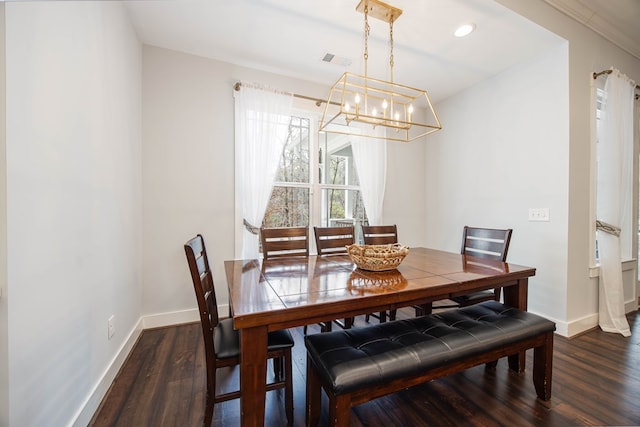 dining room featuring dark hardwood / wood-style flooring and an inviting chandelier