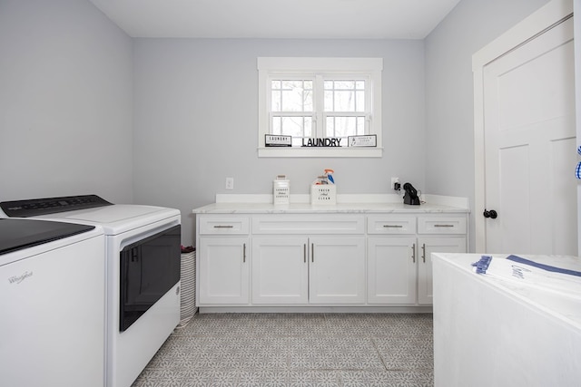 washroom featuring washer and clothes dryer and cabinets