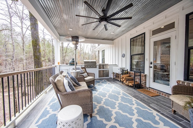 deck featuring grilling area, area for grilling, and ceiling fan