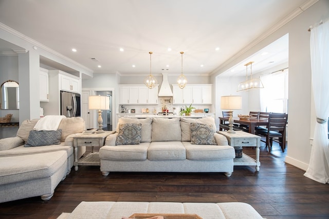 living room featuring an inviting chandelier, dark wood-type flooring, and ornamental molding