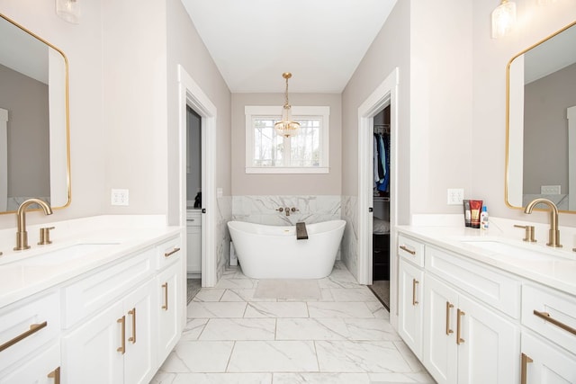 bathroom with vanity, tile walls, and a washtub