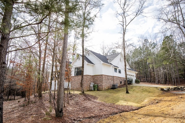 view of side of property featuring central AC and a garage