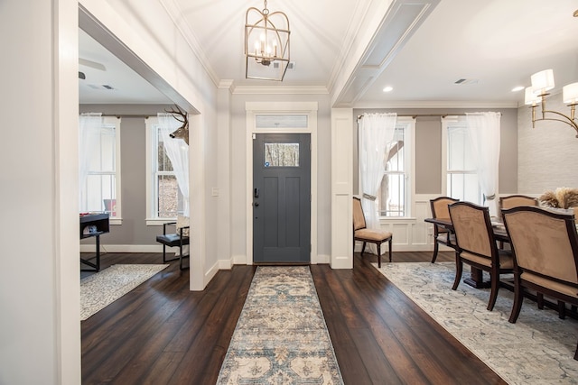 entrance foyer with an inviting chandelier, dark hardwood / wood-style floors, and crown molding