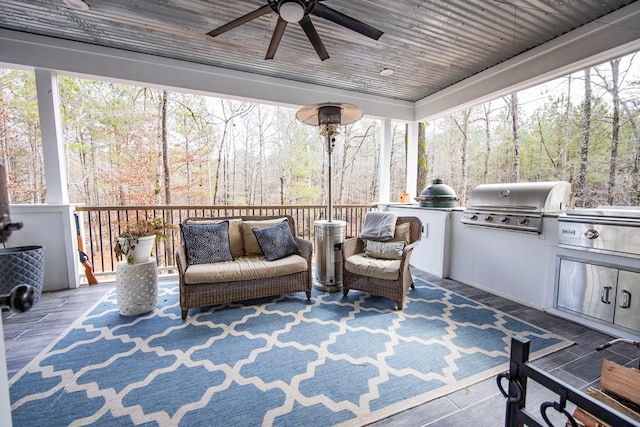 sunroom / solarium featuring wood ceiling and ceiling fan