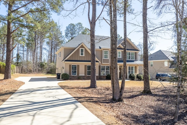 craftsman-style home featuring driveway and board and batten siding