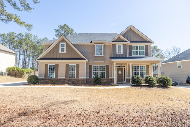 craftsman-style house with central AC, stone siding, and board and batten siding