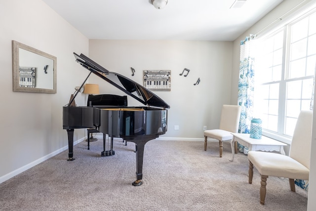 sitting room featuring baseboards, a wealth of natural light, and carpet flooring