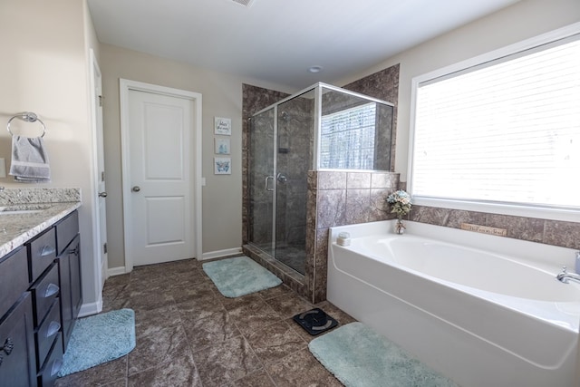 bathroom featuring a shower stall, baseboards, a bath, and vanity