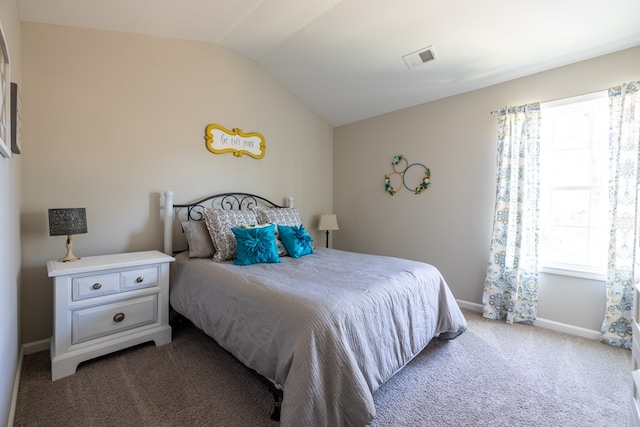 carpeted bedroom featuring vaulted ceiling, visible vents, and baseboards