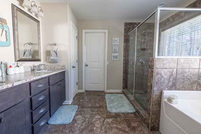 full bathroom featuring vanity, a shower stall, a bath, and baseboards