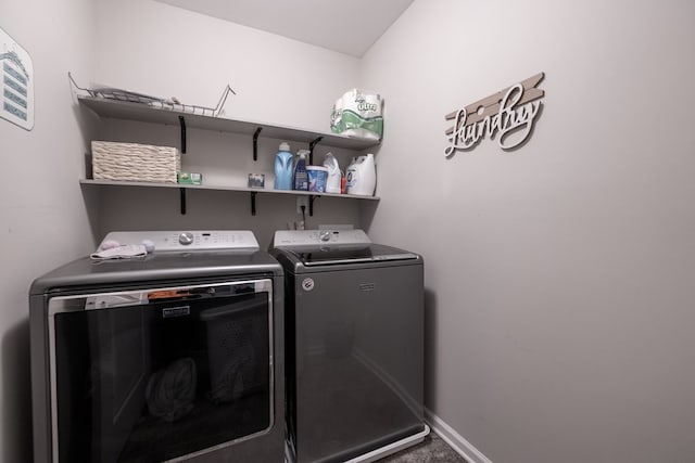 clothes washing area with laundry area, independent washer and dryer, and baseboards