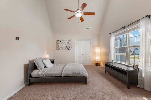 bedroom featuring visible vents, baseboards, carpet, a closet, and high vaulted ceiling