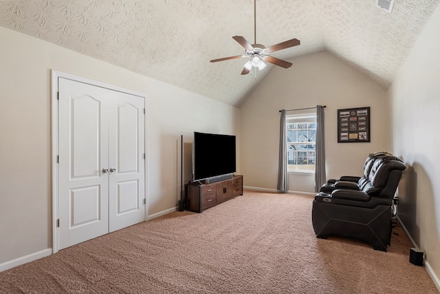 living room with baseboards, a textured ceiling, lofted ceiling, and carpet floors