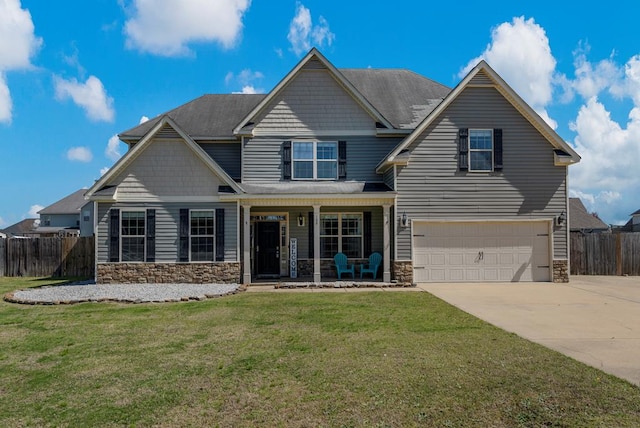 craftsman house with stone siding, a porch, concrete driveway, and fence