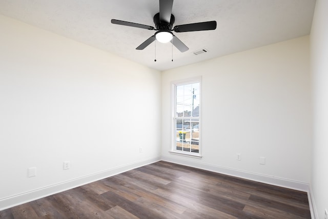 spare room featuring ceiling fan, a textured ceiling, and dark hardwood / wood-style flooring