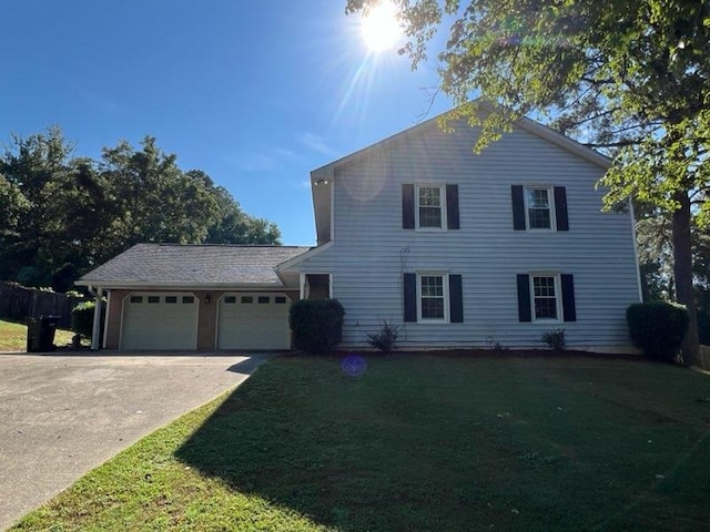 view of front of house featuring a garage and a front lawn