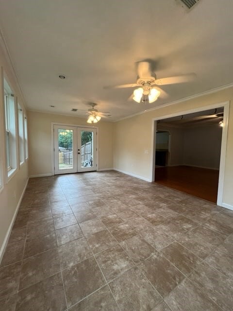 spare room featuring french doors, ceiling fan, and ornamental molding