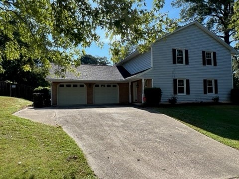 view of front of home with a front yard and a garage