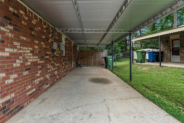 view of patio / terrace featuring a gate, fence, and a carport