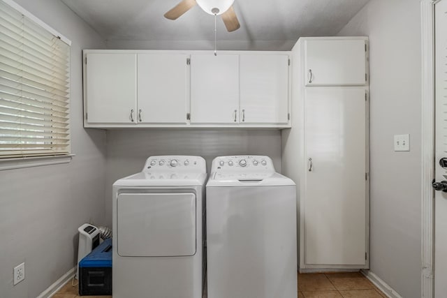 clothes washing area with cabinet space, light tile patterned flooring, a ceiling fan, baseboards, and washer and clothes dryer