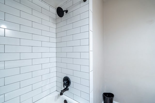 bathroom with shower / tub combination and baseboards