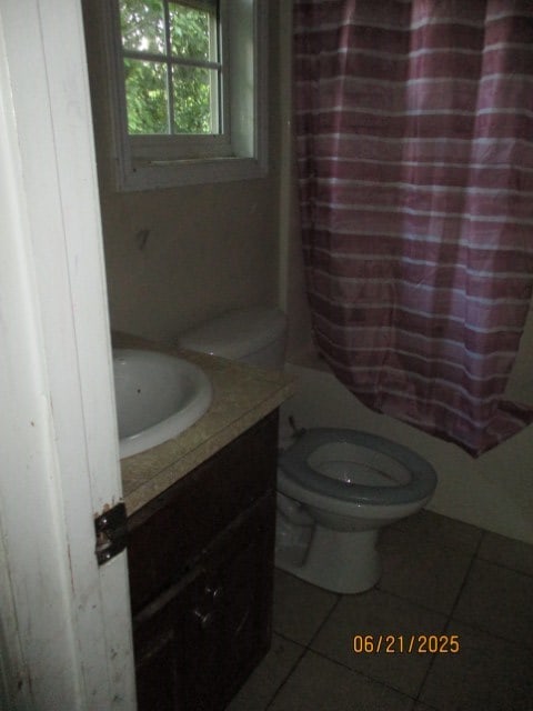 1902 6th Ct, Phenix City, AL 36867 - full bathroom featuring tile patterned flooring, vanity, and shower / bath combo with shower curtain
