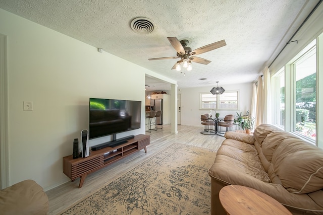 813 Crockett Dr, Columbus, GA 31904 - living room with ceiling fan, light wood finished floors, and a textured ceiling