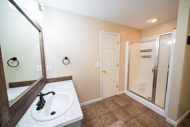 813 Crockett Dr, Columbus, GA 31904 - bathroom featuring vanity, a shower stall, a textured ceiling, and tile patterned floors
