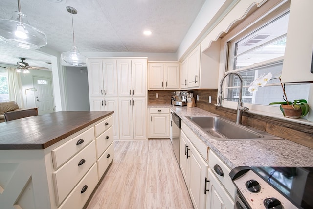813 Crockett Dr, Columbus, GA 31904 - kitchen featuring stove, wooden counters, backsplash, light wood-type flooring, and white cabinets