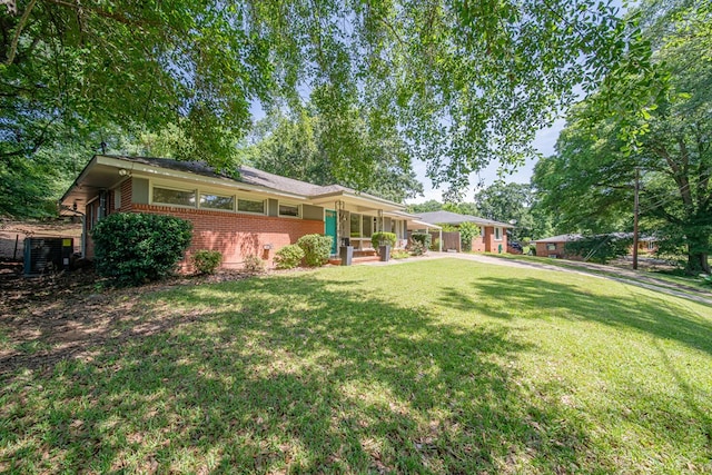 813 Crockett Dr, Columbus, GA 31904 - view of front facade with brick siding, a front yard, and covered porch